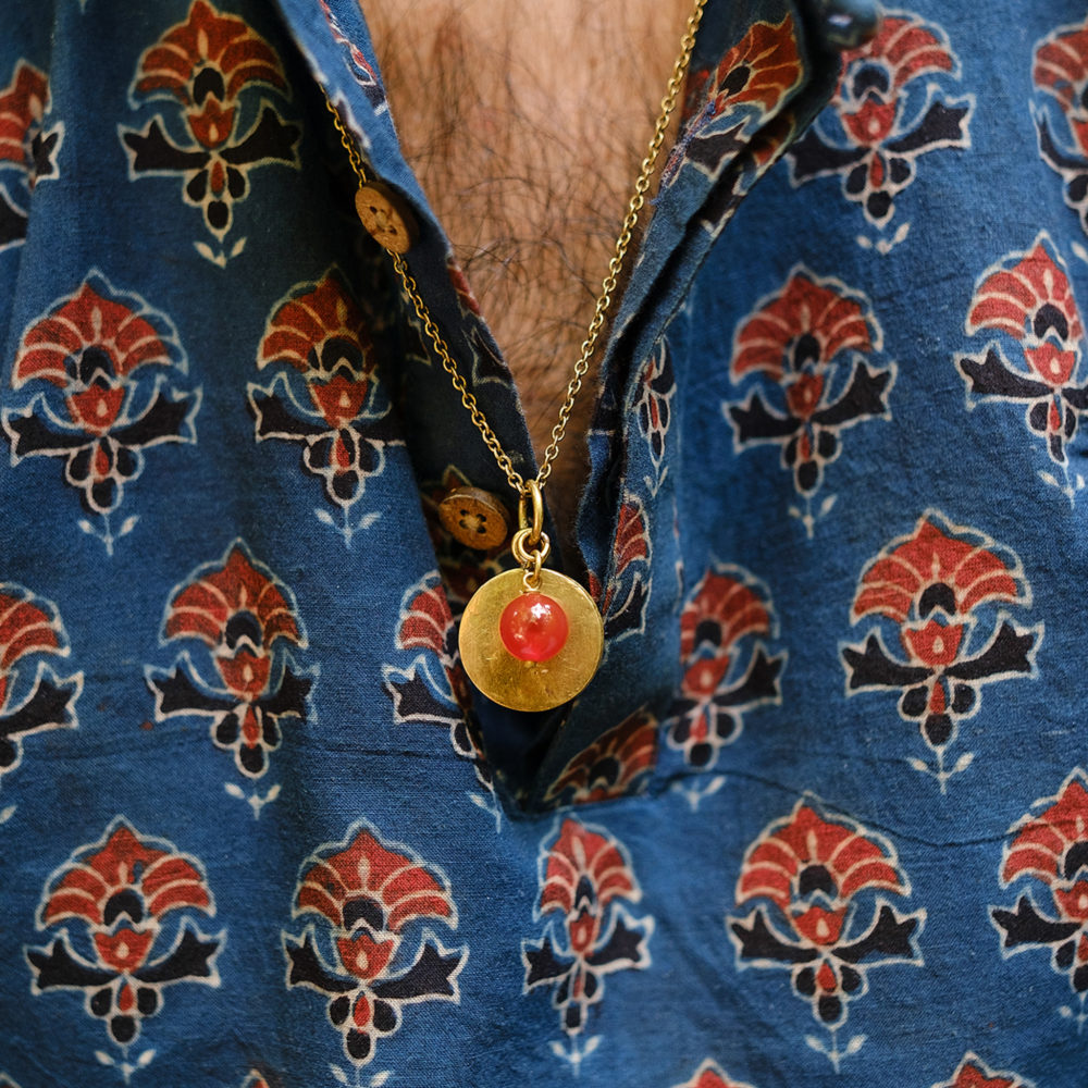 Man Wearing Om with Carnelian Bead Necklace