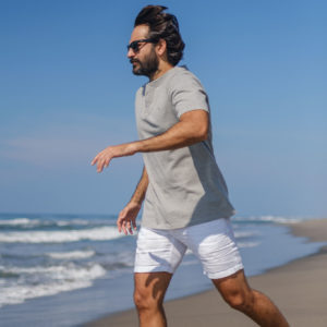 Man in motion on beach in Barra Cotton Tee Grey