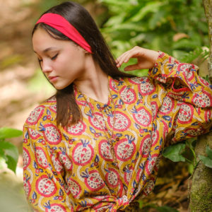 Woman wearing La Quebrada Cotton Tunic Long Sleeve in Jungle